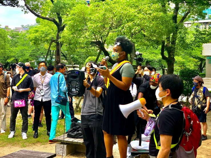 a large group of people standing around talking to each other