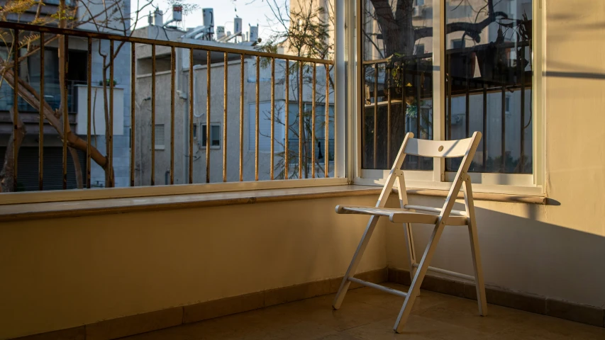 an empty chair on a small balcony