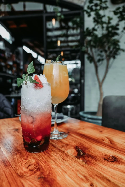 a couple of drinks sitting on top of a wooden table