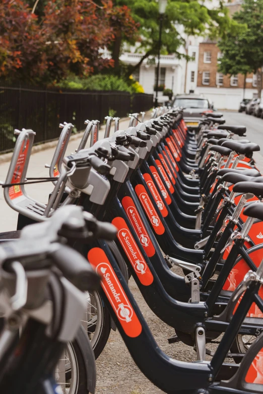 a long line of bikes parked in a city street