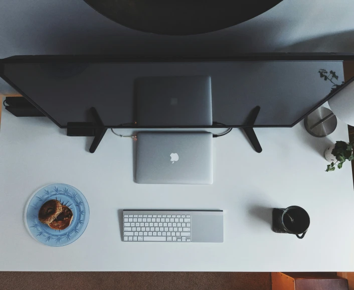 a keyboard and a computer monitor on top of a table