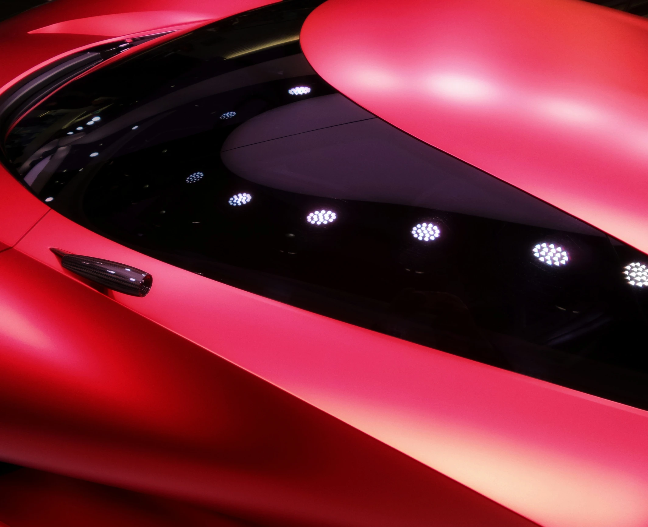 an futuristic car with red lighting and circular shaped windows