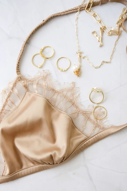 an assortment of gold - plated jewelry and  with a satin skirt