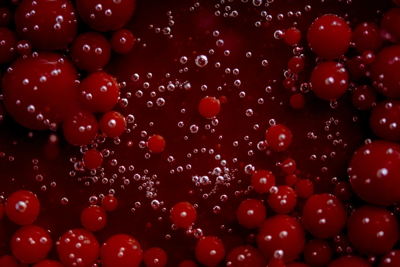 a bunch of water bubbles that are red