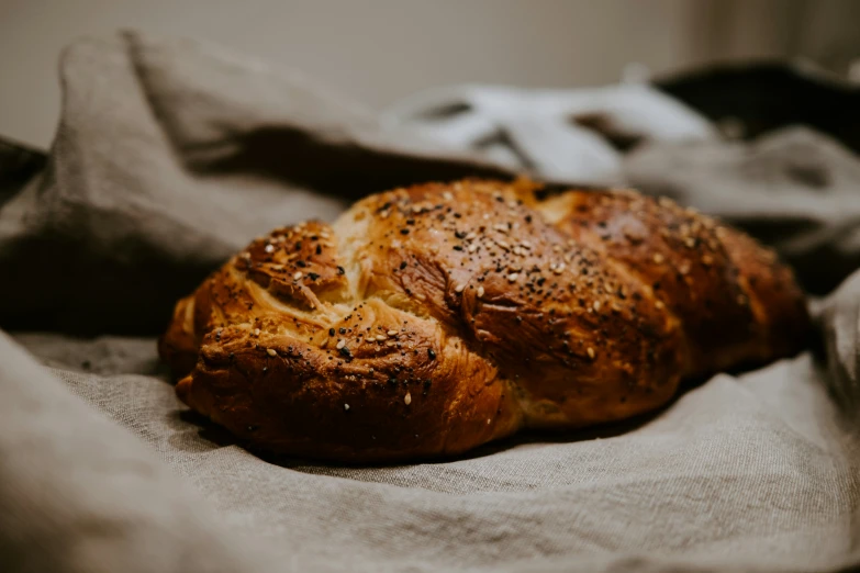 a delicious croissant is laying on a piece of linen