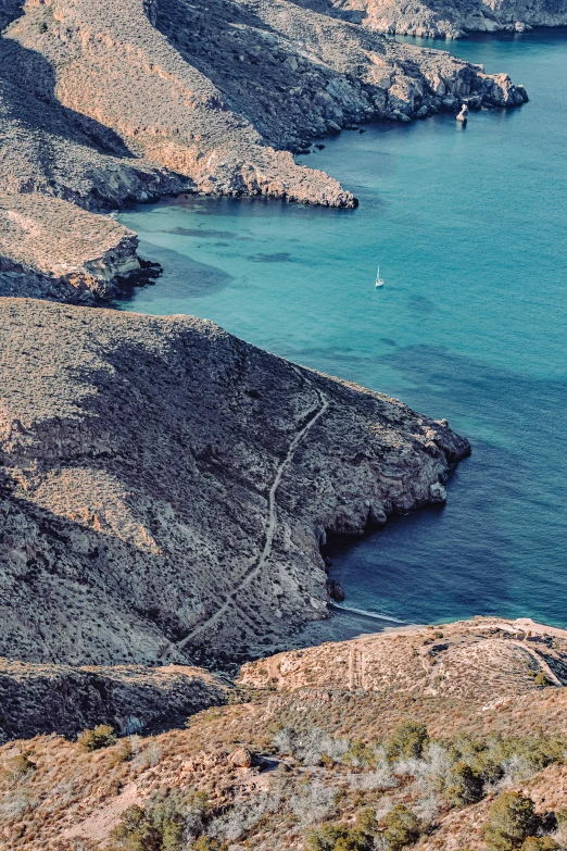 a small sail boat sailing on top of the water