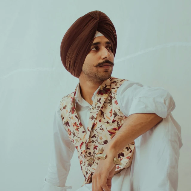 a man wearing an indian turban, collared shirt and tie