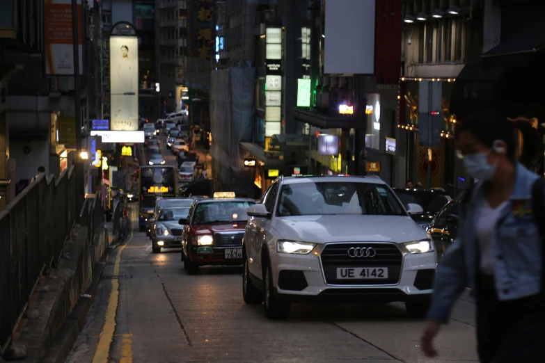 several cars are driving through a city street