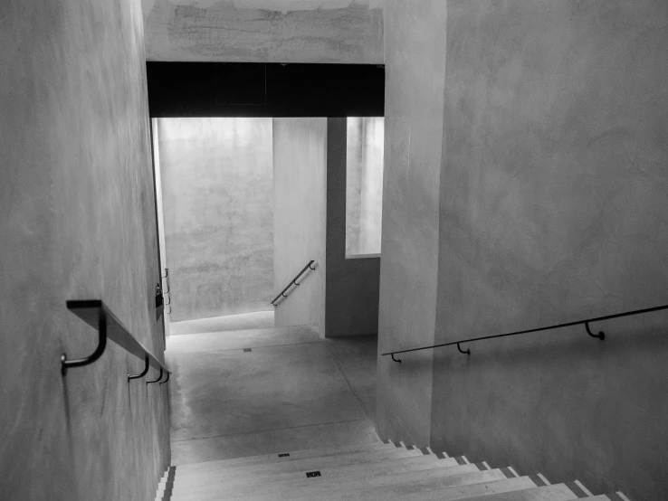 an empty building with a large staircase and railing