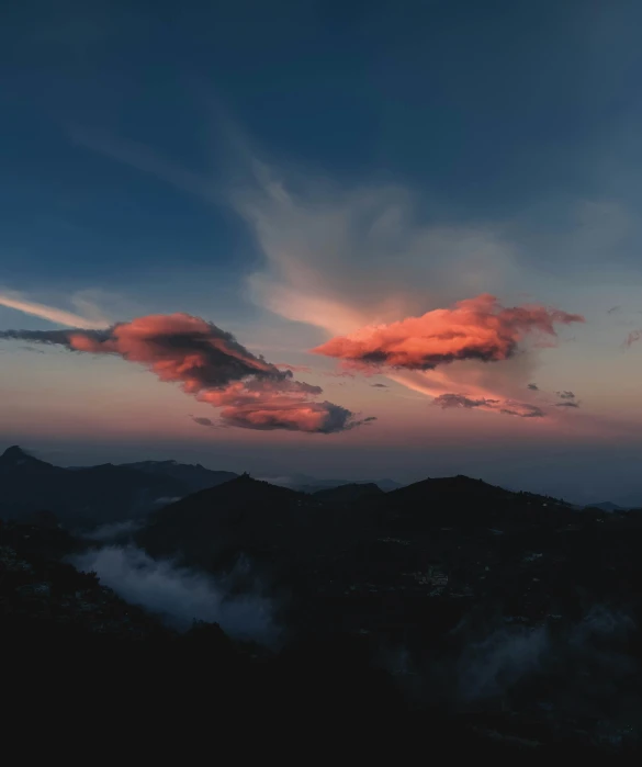 an artistic s of a pink cloud over hills