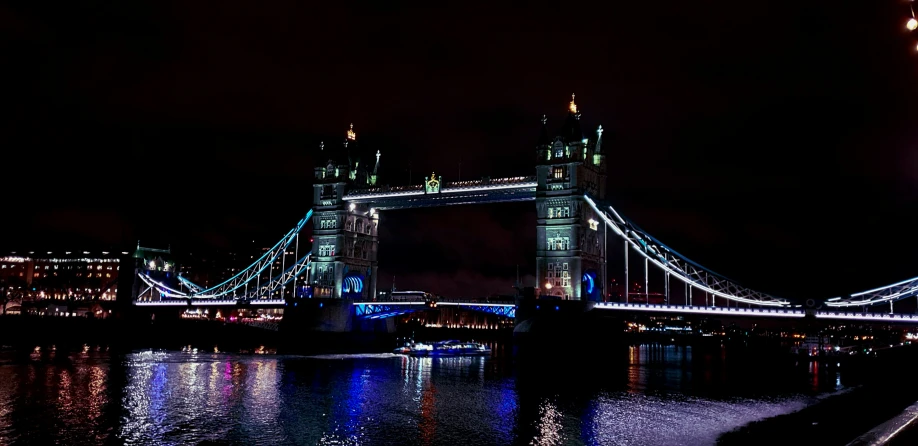 a long bridge at night with lights on top