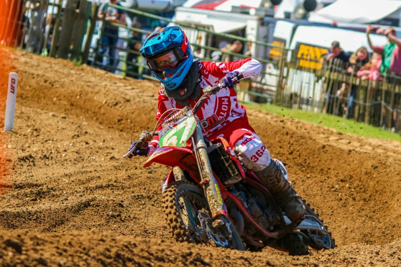 a man riding on the back of a dirt bike down a hill