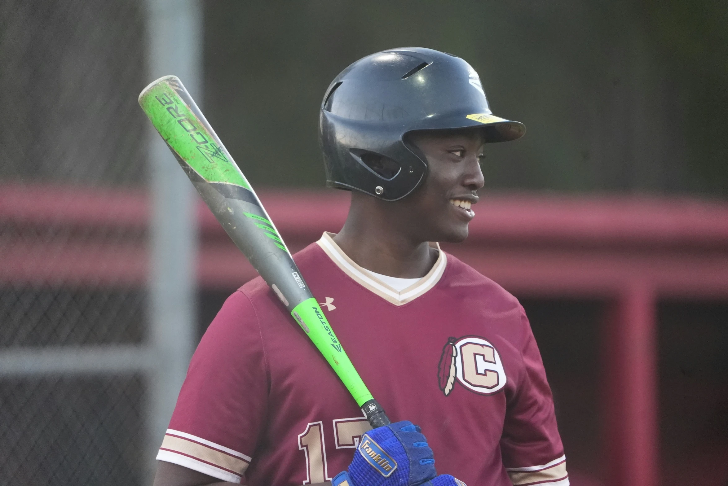 a man in a baseball uniform holding a bat