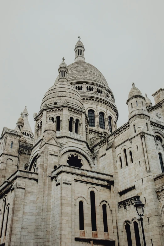 a tall, old building that has some windows and a domed top