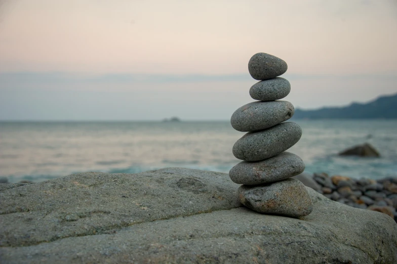 a stack of rocks is balanced on top of a rock
