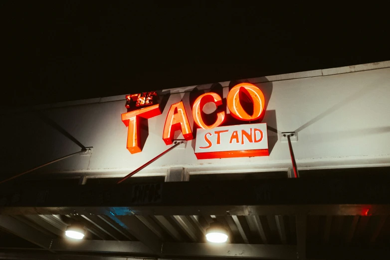 an old taco stand is seen at night