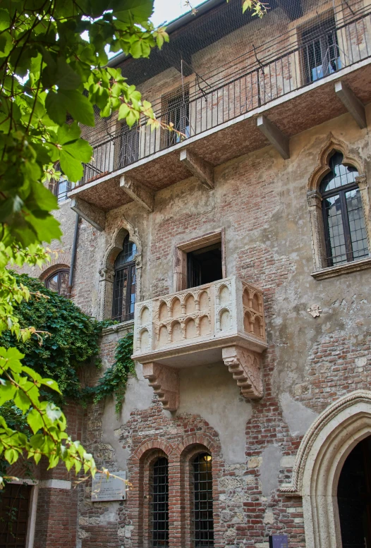 an old, ornate brick building with balcony and balconies