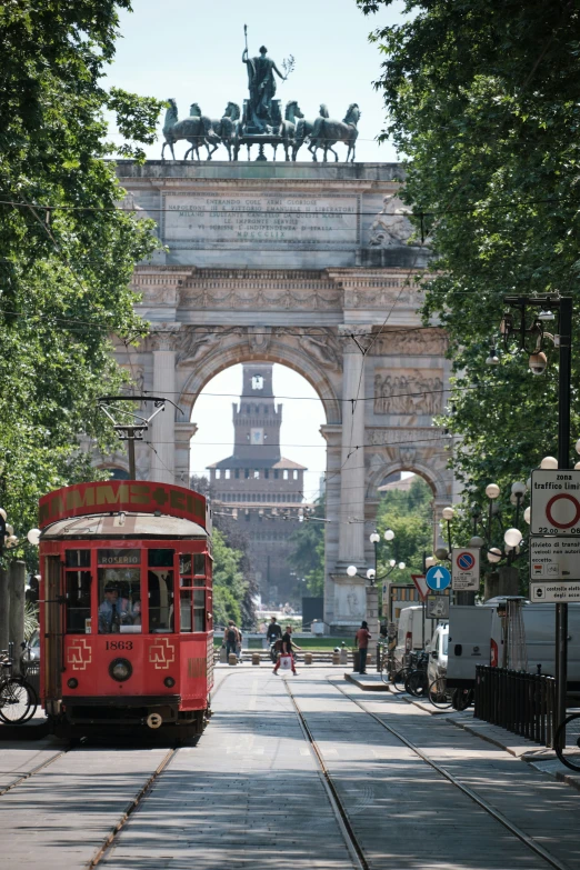 the trolley is parked by the tall archway