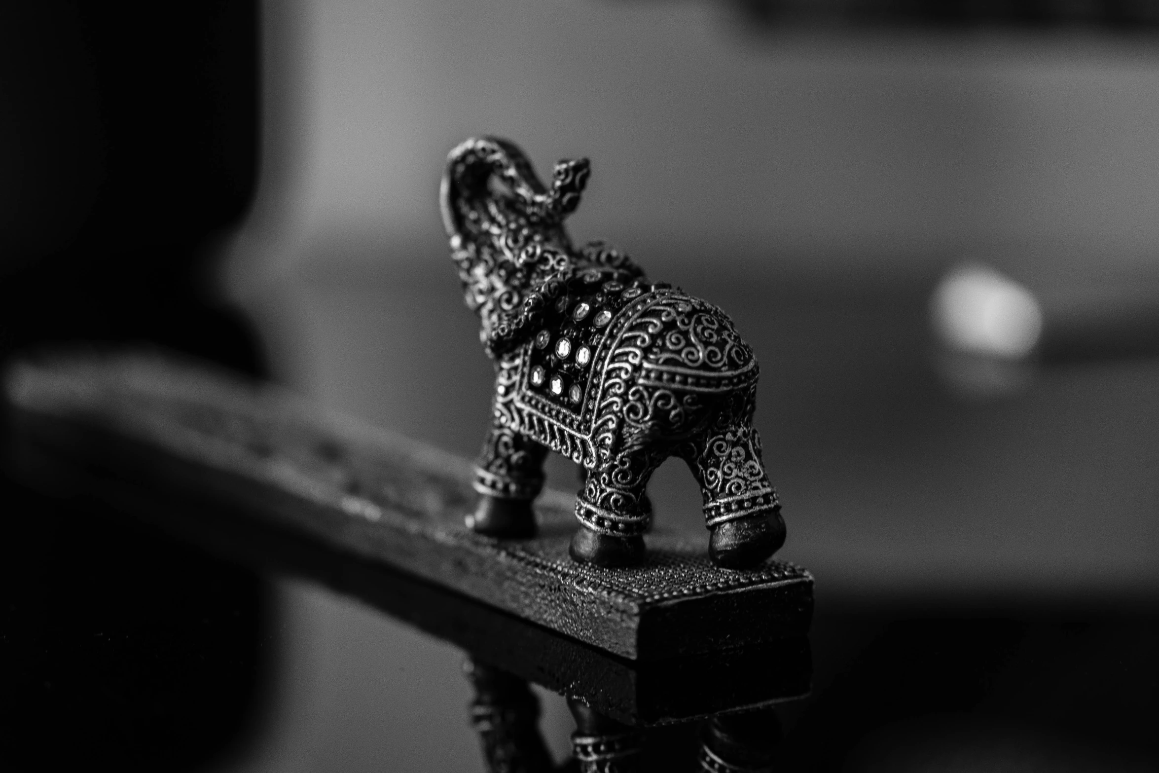 an elephant figurine is standing on top of a table