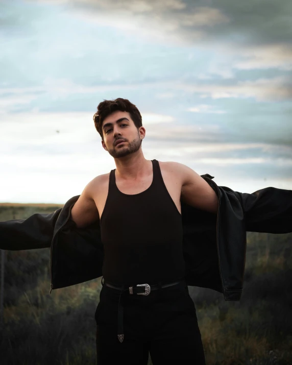 a man is posing with his arm wrapped in black