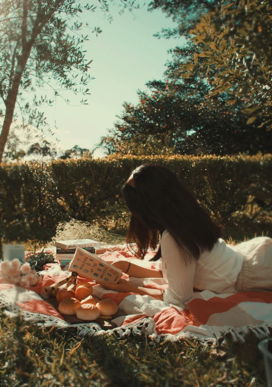 the woman is laying on her back with her book