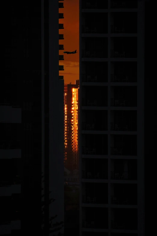 the setting sun is shining on tall buildings