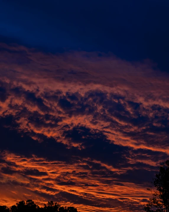 a view of clouds with a dark blue sky in the background