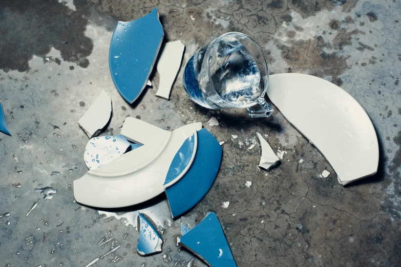 debris from a broken and damaged glass pitcher and bowl