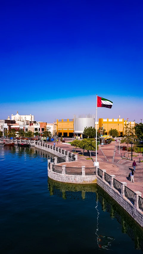 a bridge crossing a body of water in front of city buildings