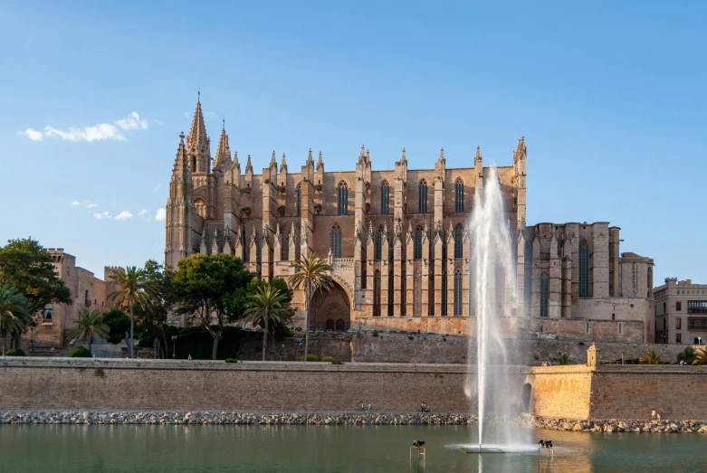 an old cathedral and its pool of water surround it