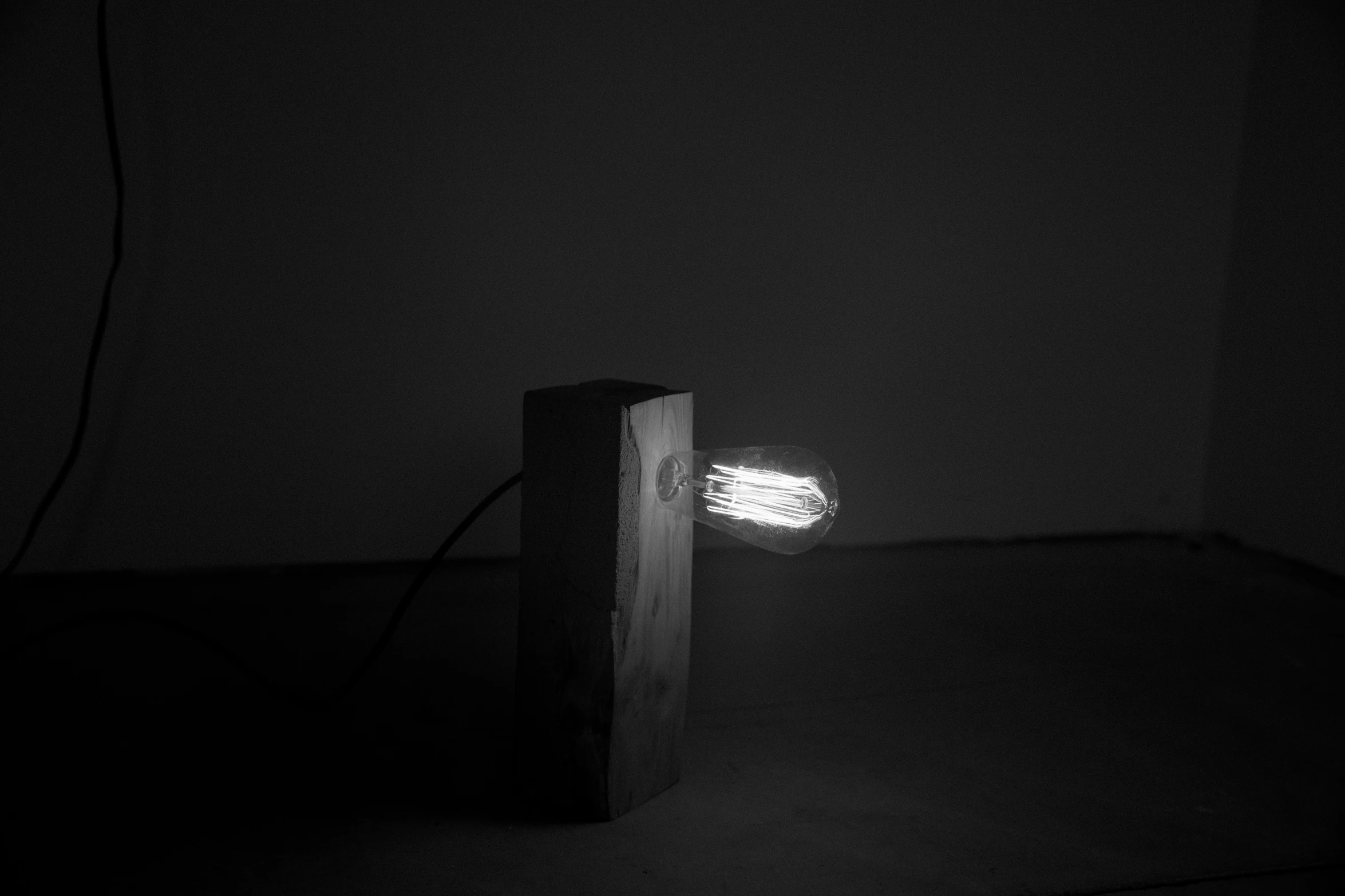 an empty, dark room with a lit brick