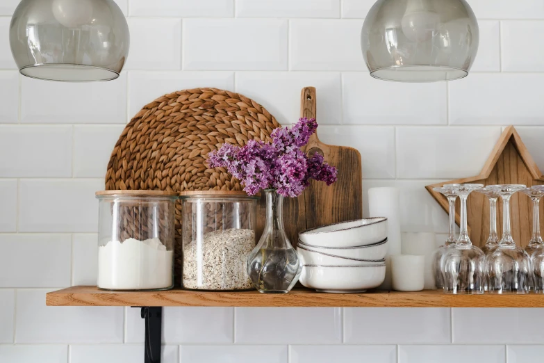 some jars are sitting on a shelf and are filled with dishes