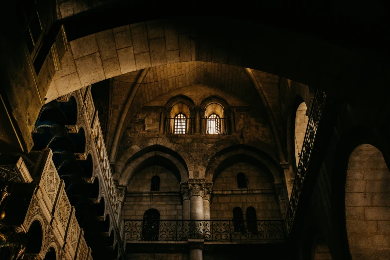 looking up into a dark cathedral with multiple floors