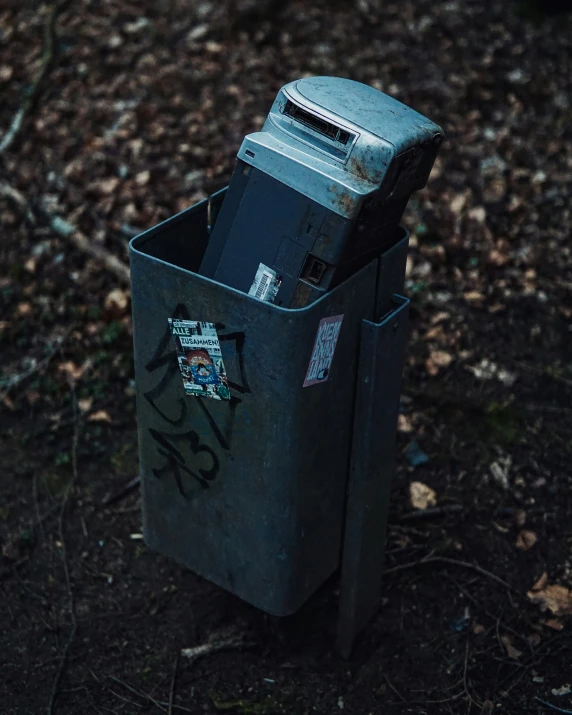 a trash can with writing on the top of it