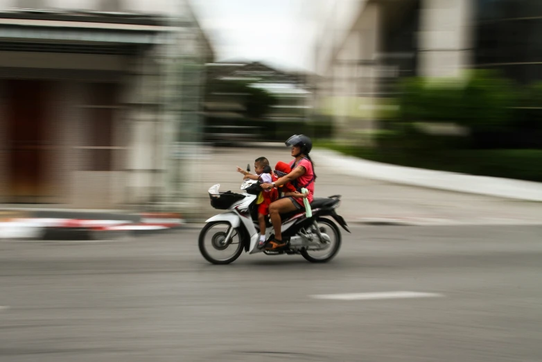 an image of a woman riding on the back of a motorcycle