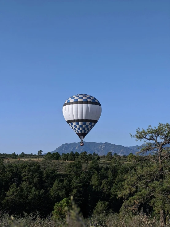 large inflated  air balloon flying in the blue sky
