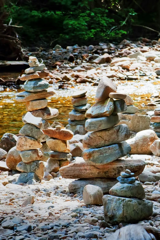 an assortment of rocks piled on top of each other in the ground