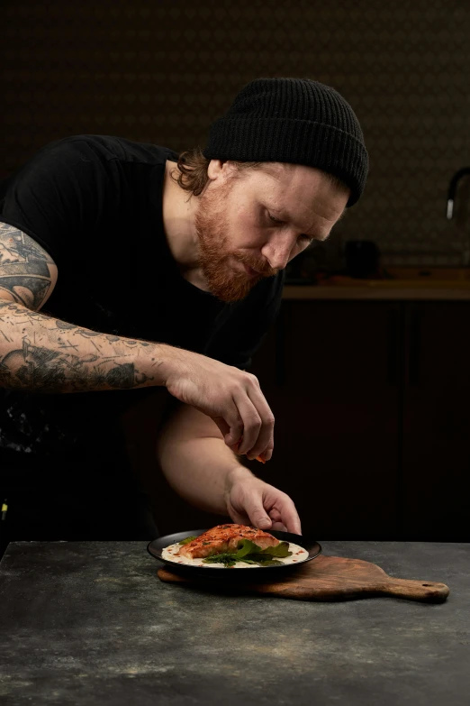 a man eating a plate with food at the table