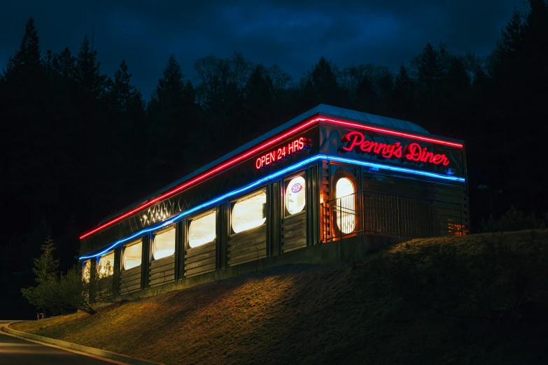 a lighted shop on the side of the road