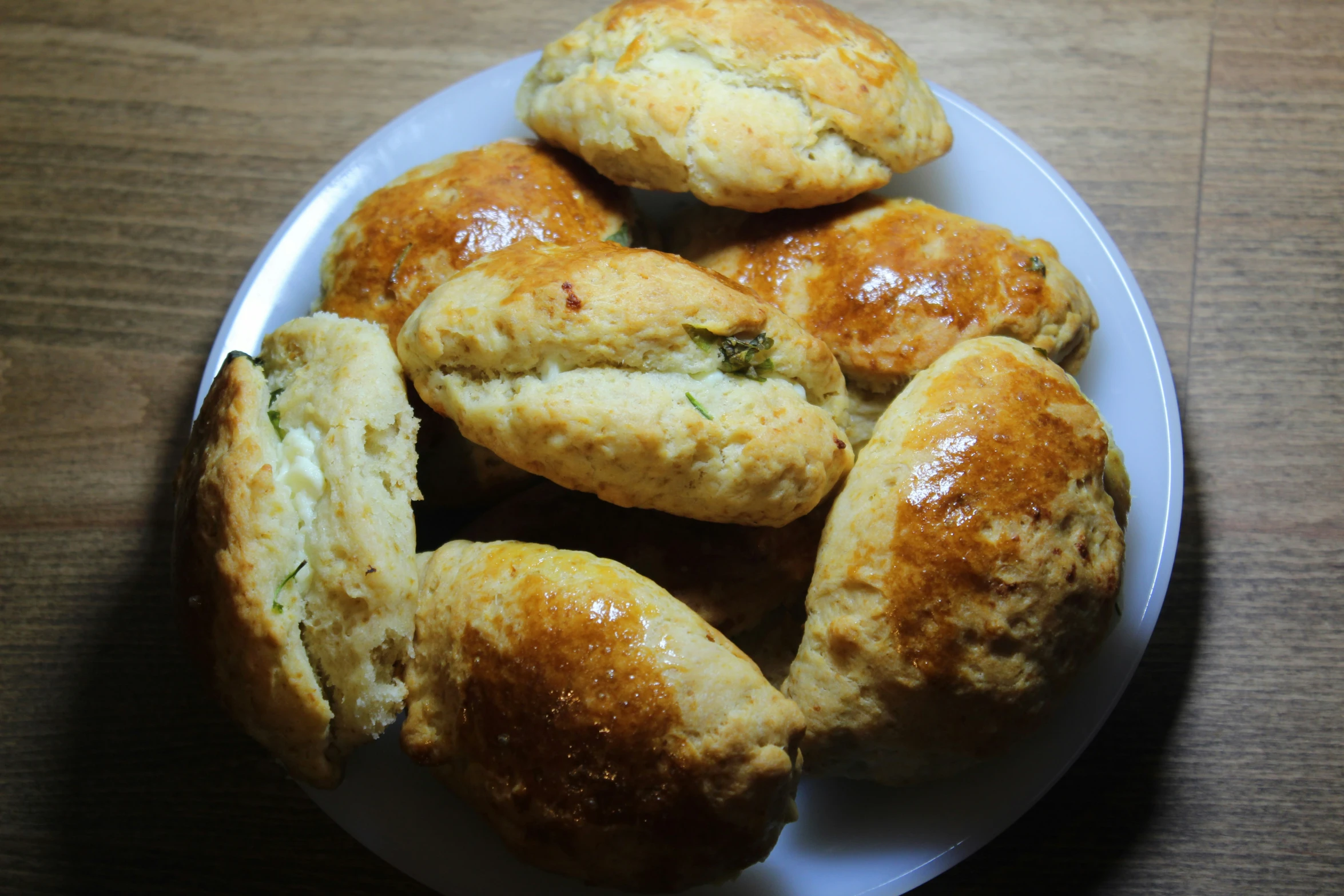 several biscuits sitting on top of a white plate