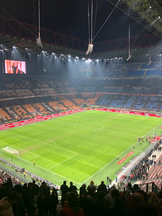 a soccer field at night with bright lighting