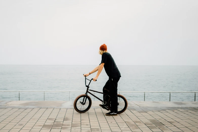 a person riding a bike near the ocean