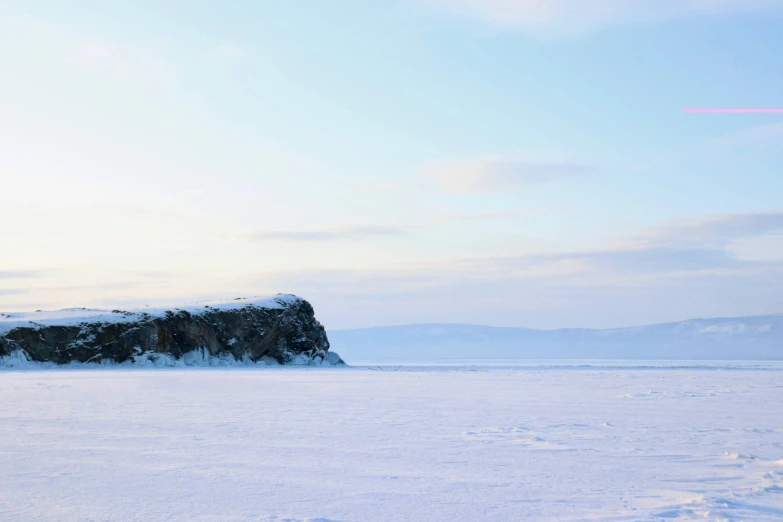 some people walking across some snow with a ski poles in hand