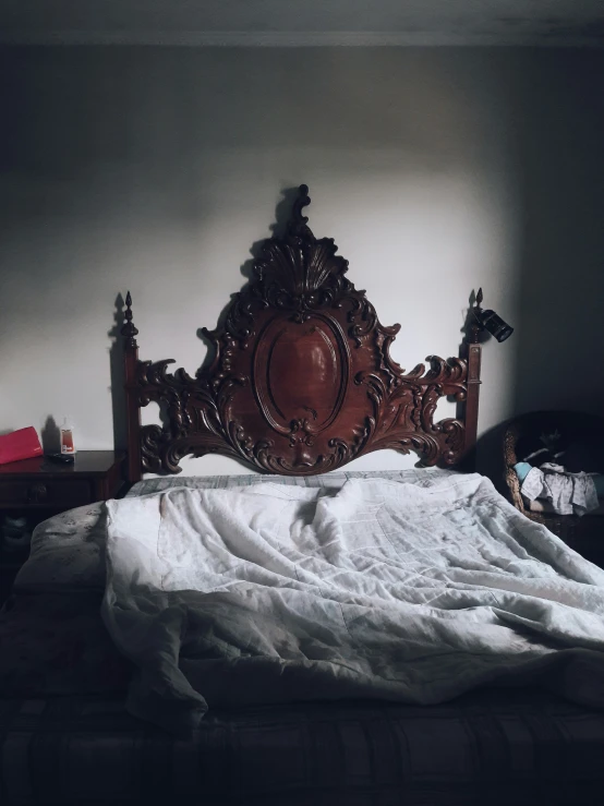 a bedroom with white and gray walls and a wooden headboard