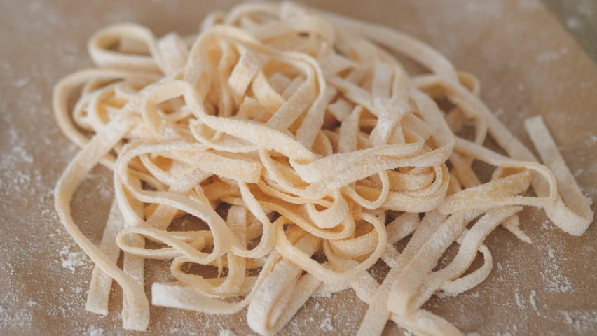 a pile of uncooked pasta on top of a table