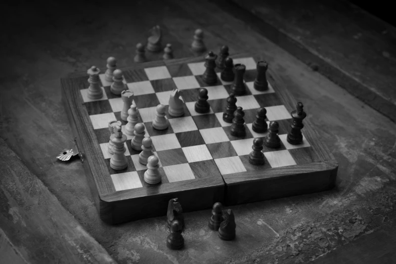 a wooden chess board set up on a ground