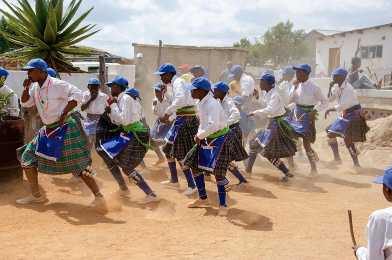 an old group of children with some dressed in traditional attire