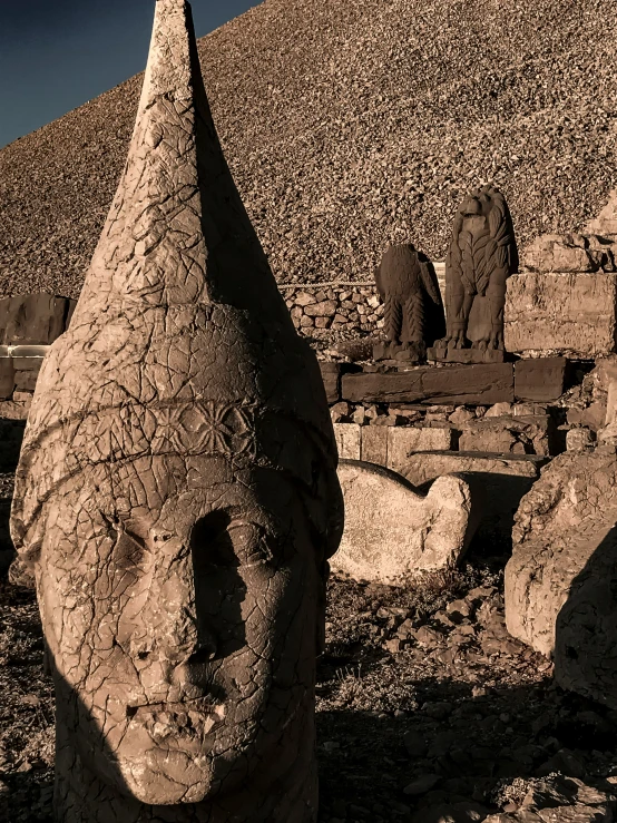 three clay heads are shown sitting in front of an outdoor table