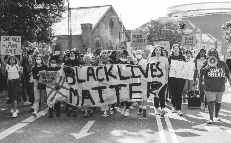 black lives matter sign and people holding up placards