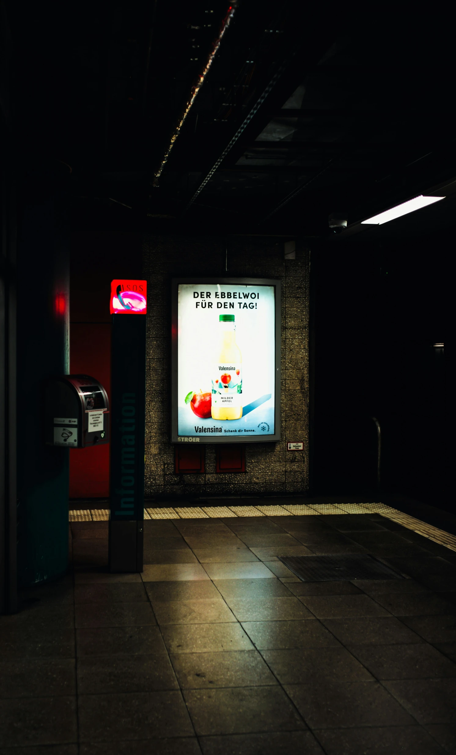 an empty subway station with a large tv